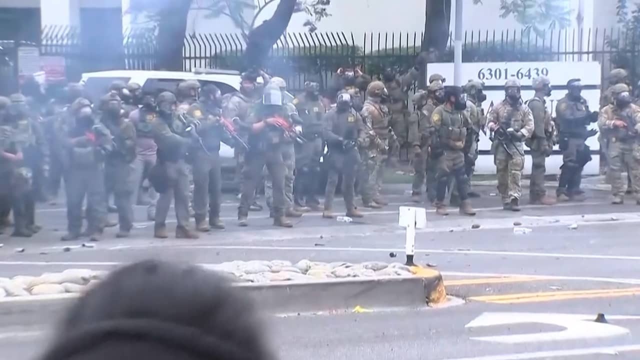 Image from video: Agents throw tear gas at demonstrators in Los Angeles
