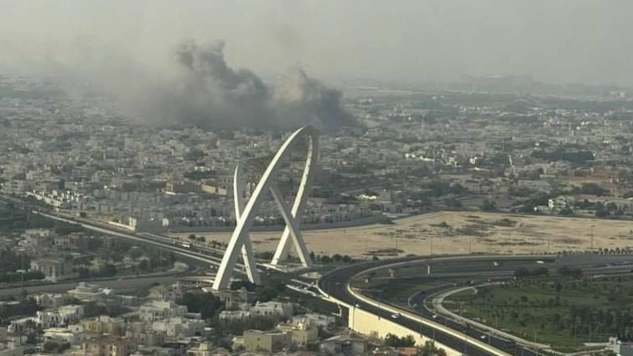 Image from video: plumes of smoke above Qatarese town of Doha after Israeli air raid