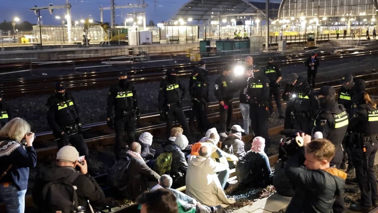 Activists Extinction Rebellion are sitting on tracks near Amsterdam Central Station
